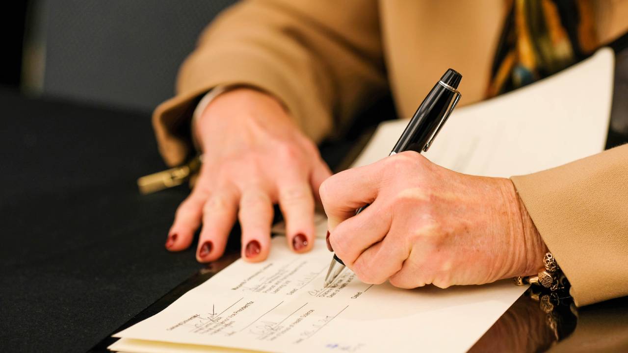 Hands signing articulation agreement