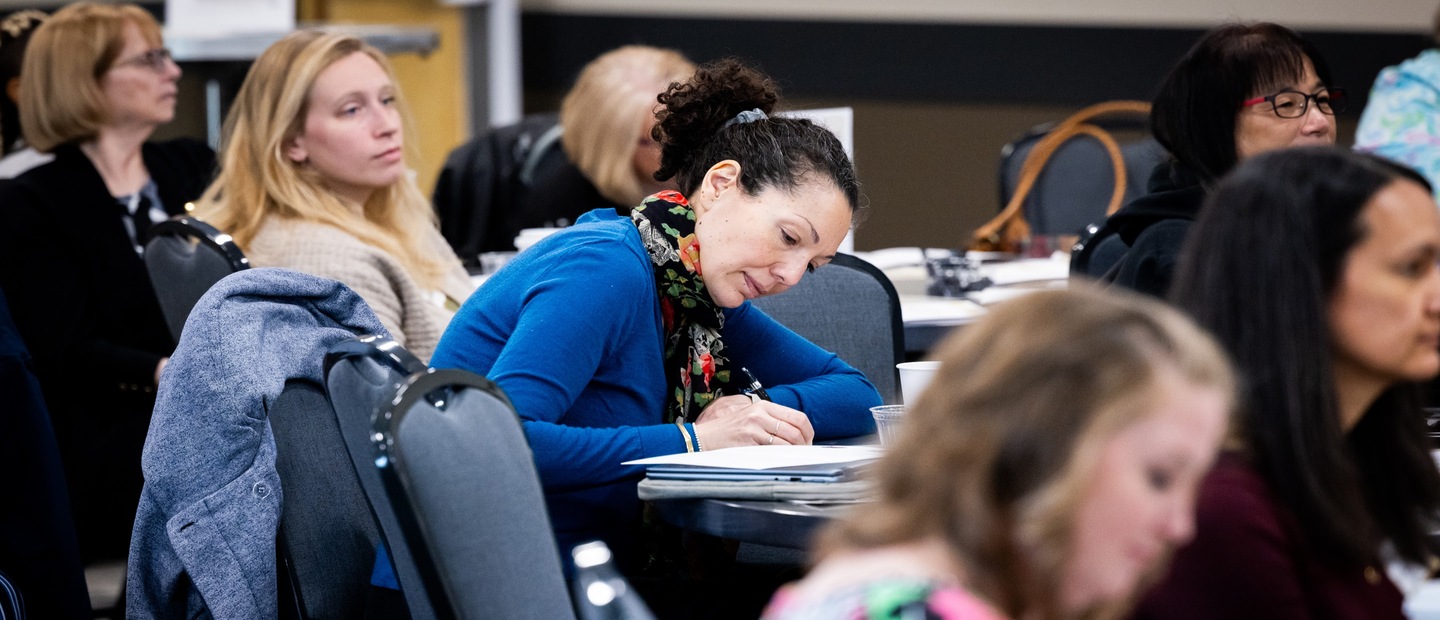 Professional Development banner Professionals take notes at lecture