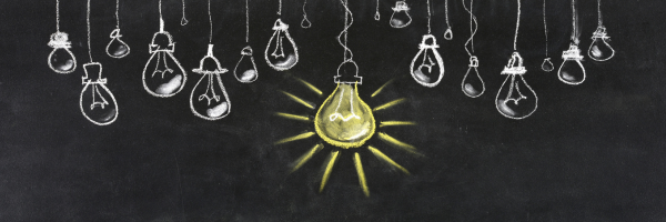 light bulbs suspended from a blackboard