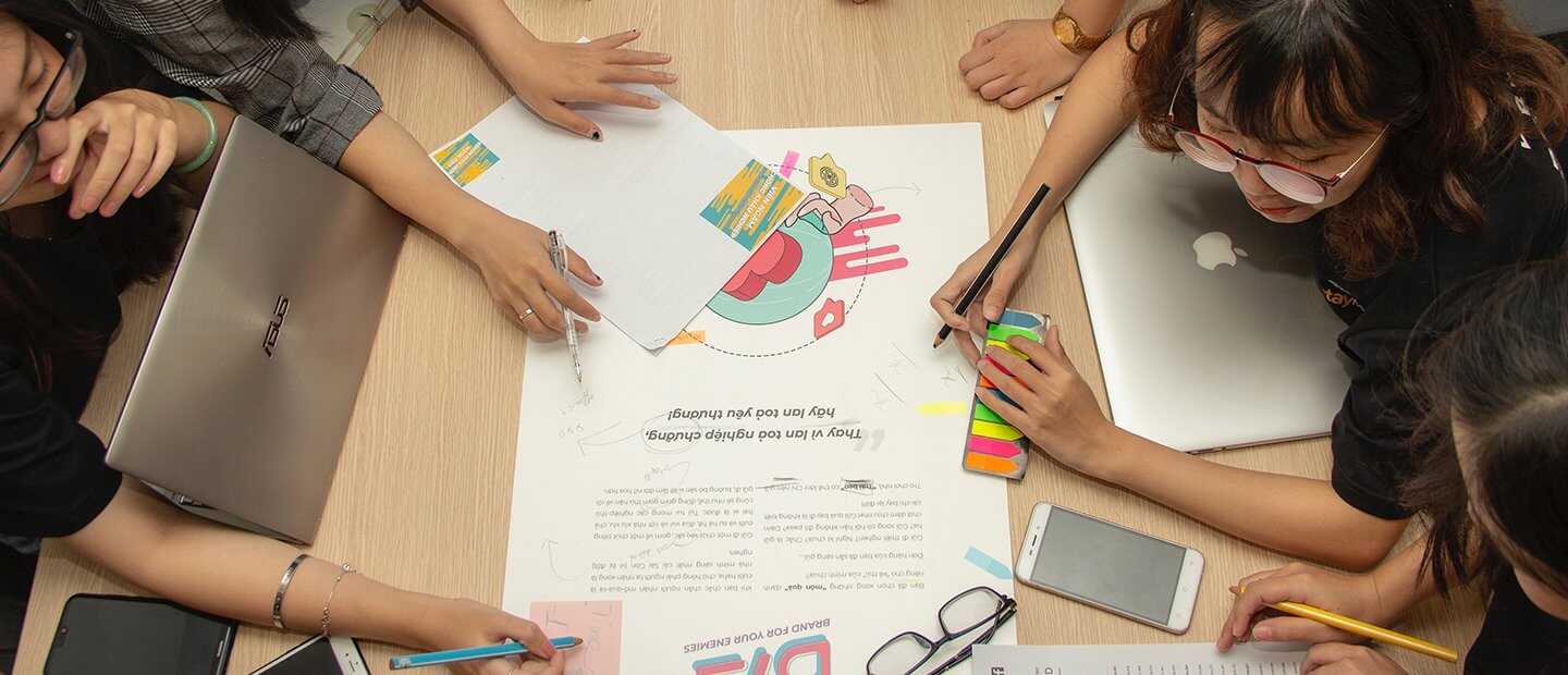 student collaborating on a poster assignment