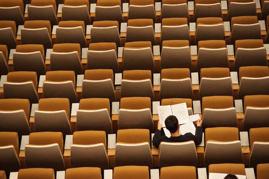Student alone in a large class.