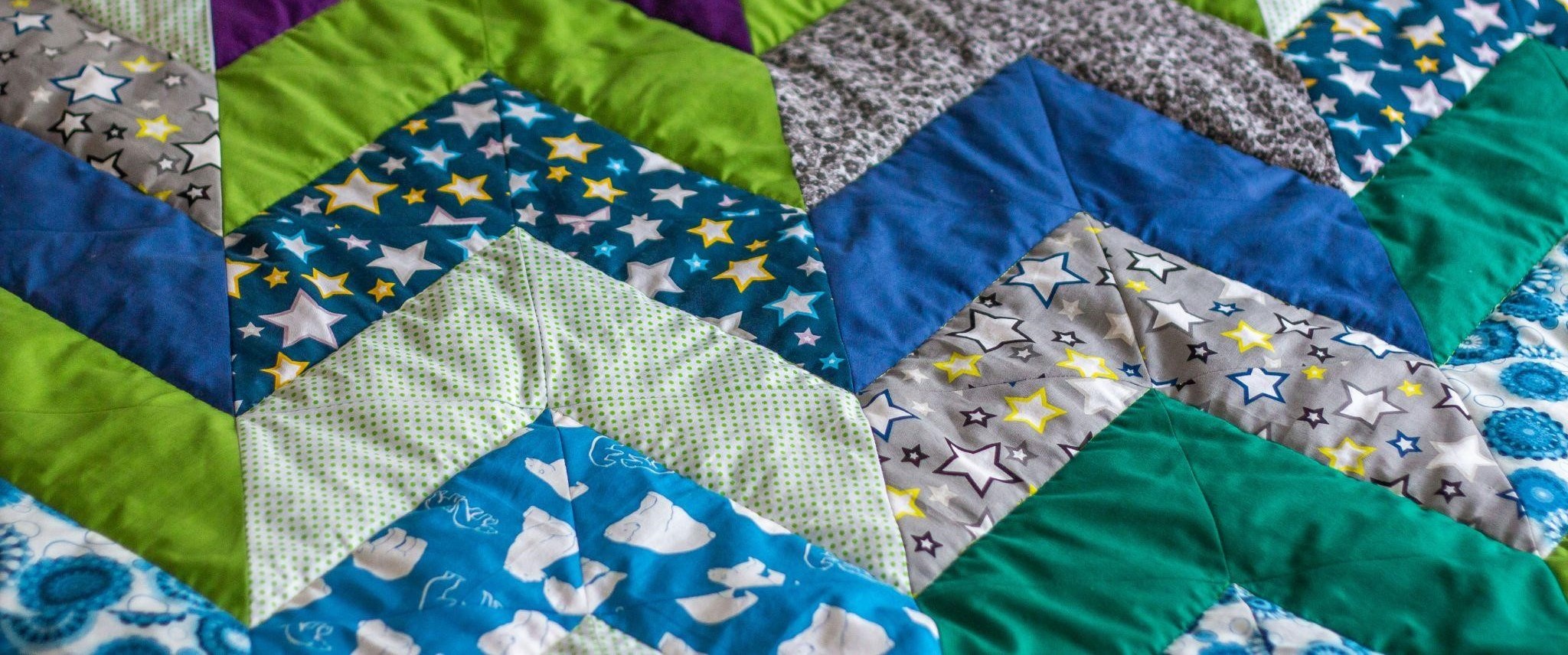 Close-up image of a quilt displaying an assortment of colorful patches