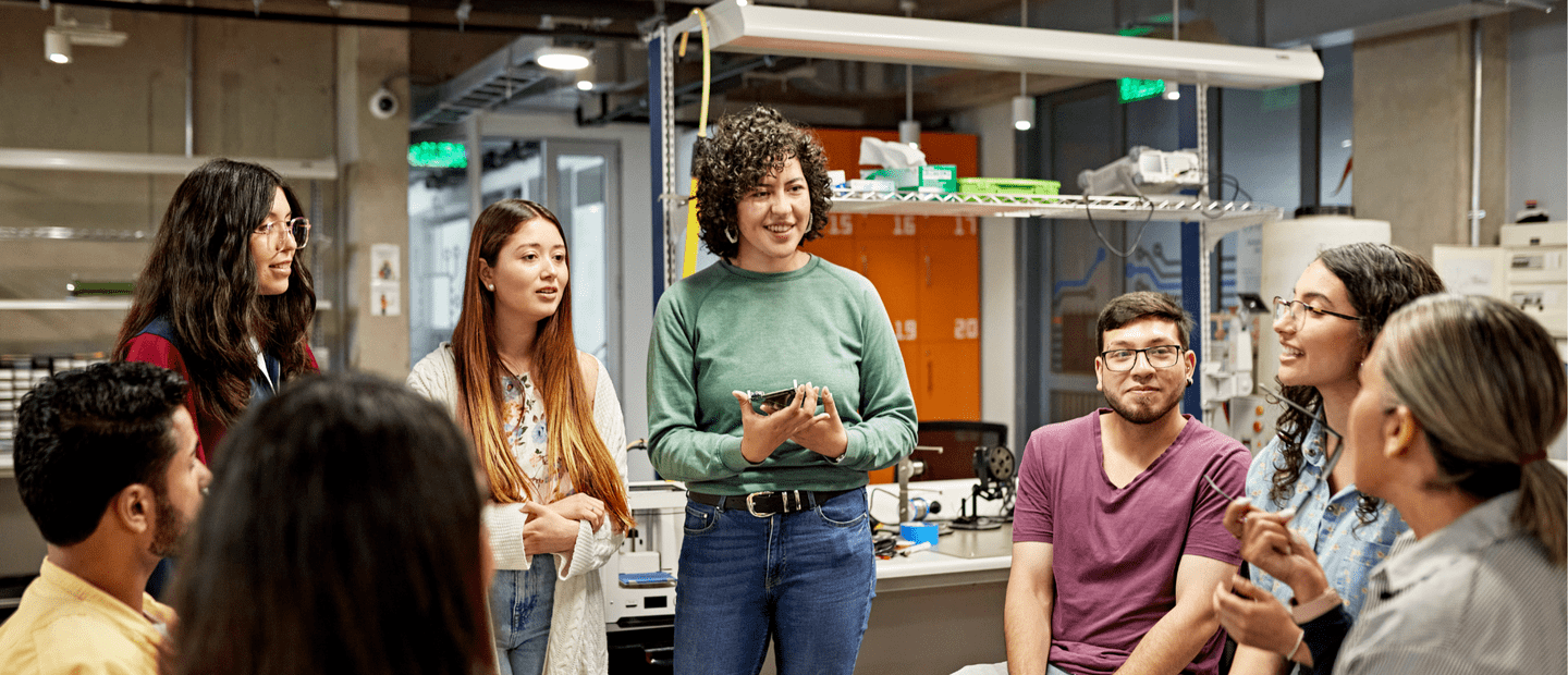 group of students having a discussion with the professor