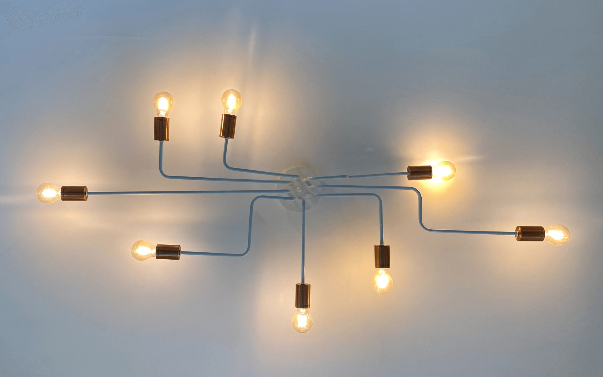 Eight lightbulbs on blue background