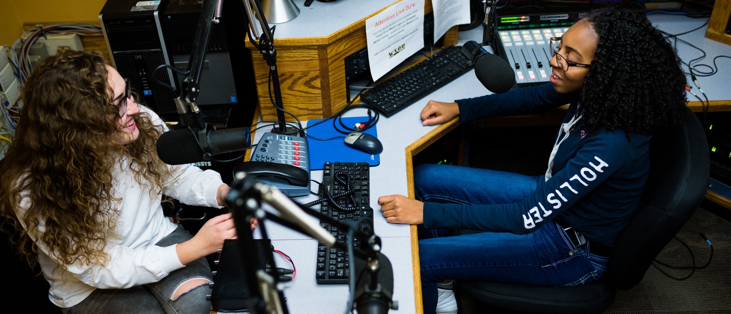 Journalism and Media Studies Banner Two students talking on air in the WXOU radio station