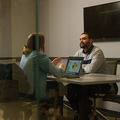 Two ESL students looking at a laptop together