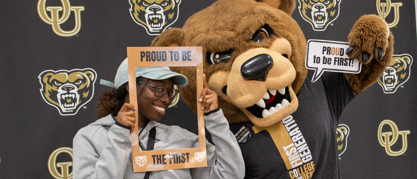 First-generation Students A first generation college student posing with the Grizz mascot