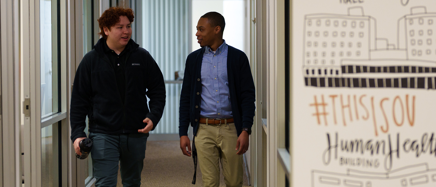 First Year Resources Banner Two young men walk together down a hallway in a building on O U's campus.