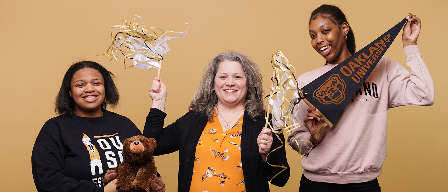 Faculty, Staff and Retirees Banner Oakland University staff with banners and pom poms