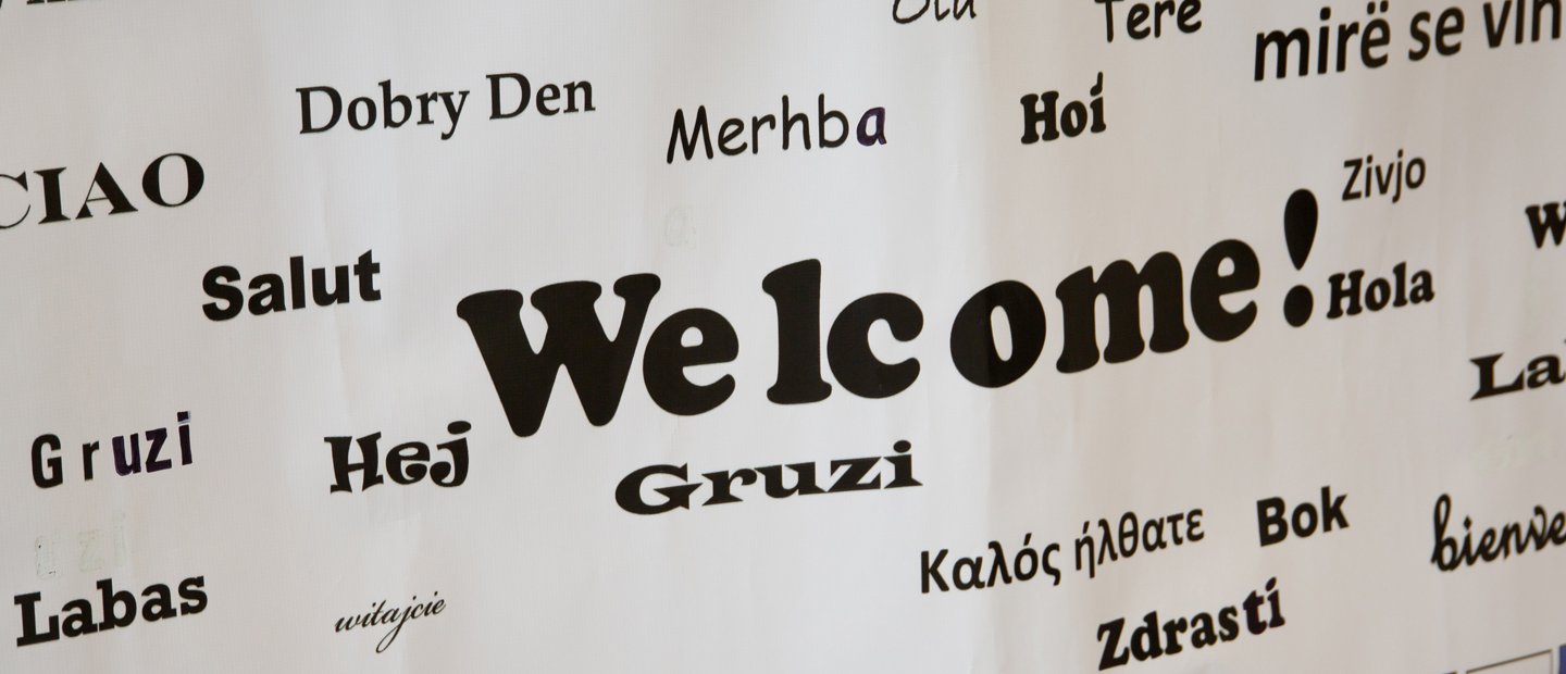 International.jpg a sign that says Welcome! in English and many other languages