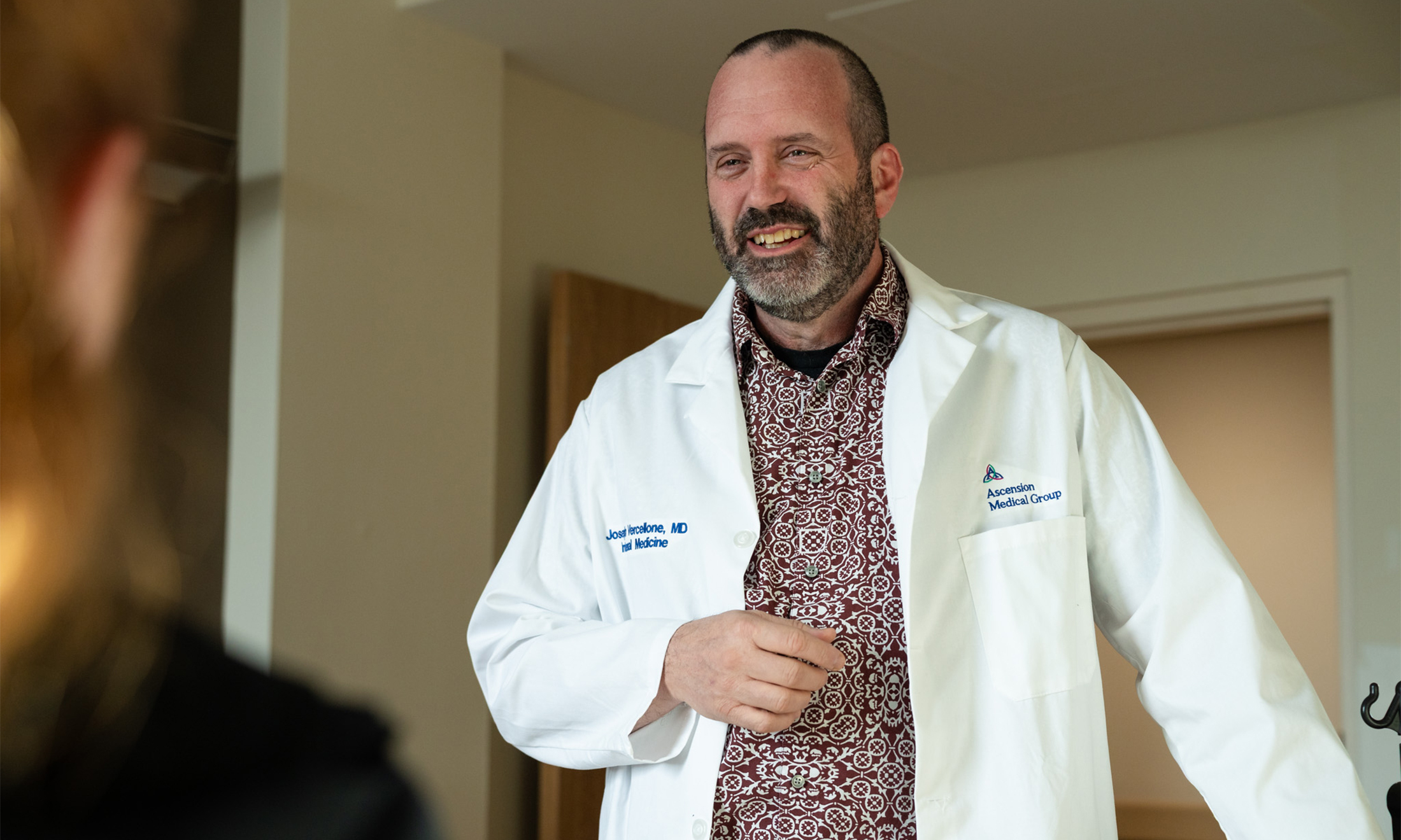 Joe Vercellone, M.D., talks with a patient