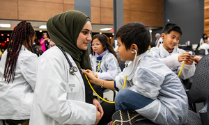 An OUWB student talking to a patient