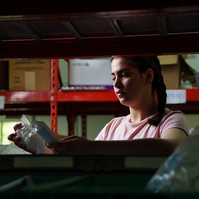 A person getting equipment off a shelf