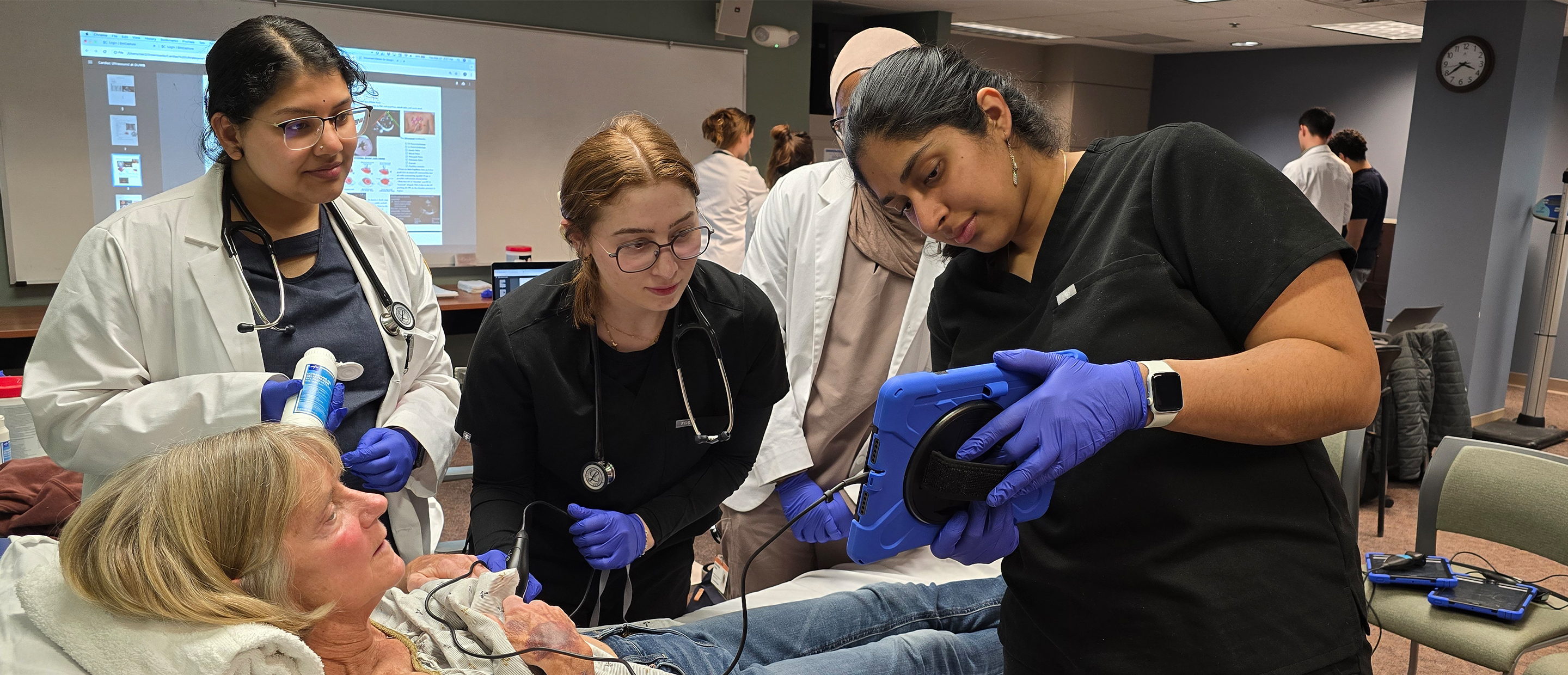 Clinical Skills Center Banner An image of students with a standardized patient