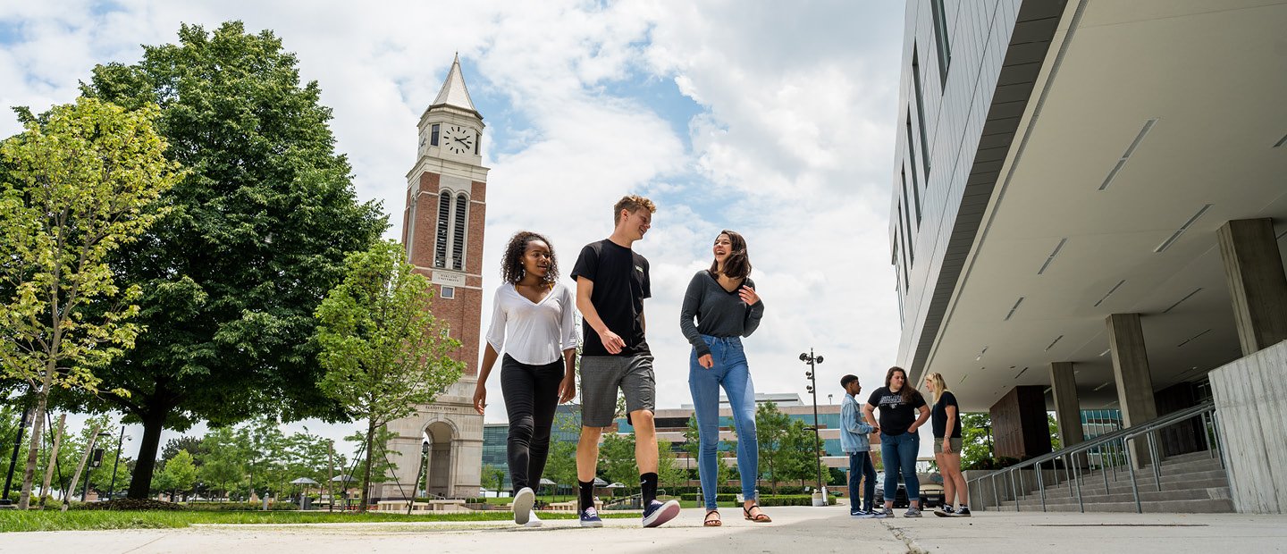 Disclosures and Complaints Banner students walking on Oakland University's campus with a clock tower in the background