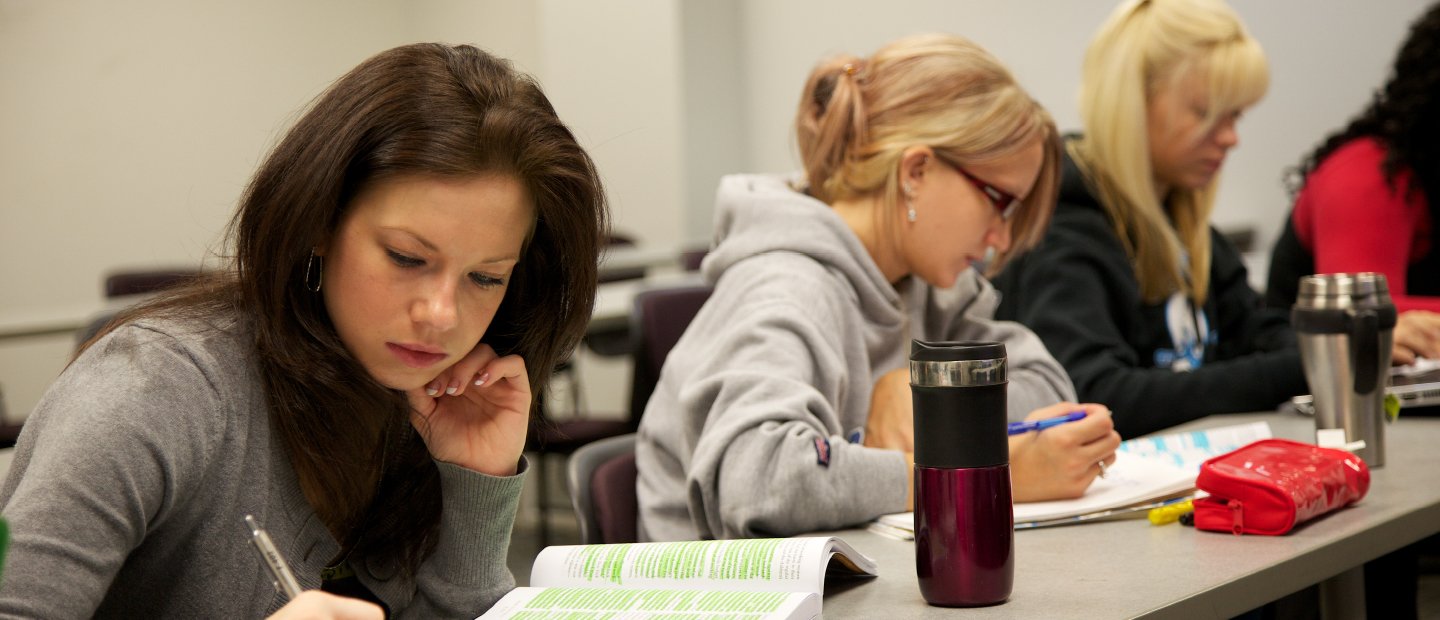 POL-23270_SubBanners_UndergradPrograms.jpg Students seated at a long desk, taking notes.