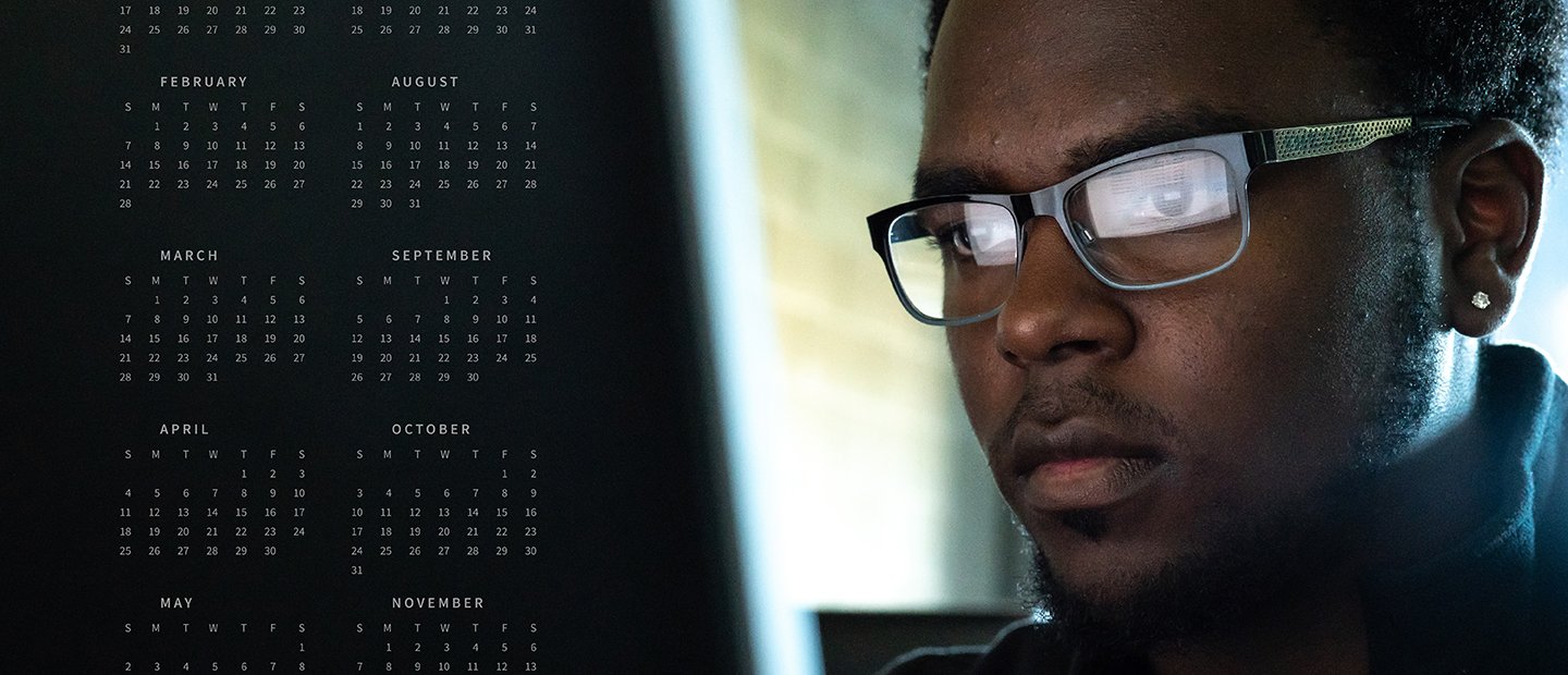 Calendars Banner Man looking intensely at a screen with a few months of calenders on the left