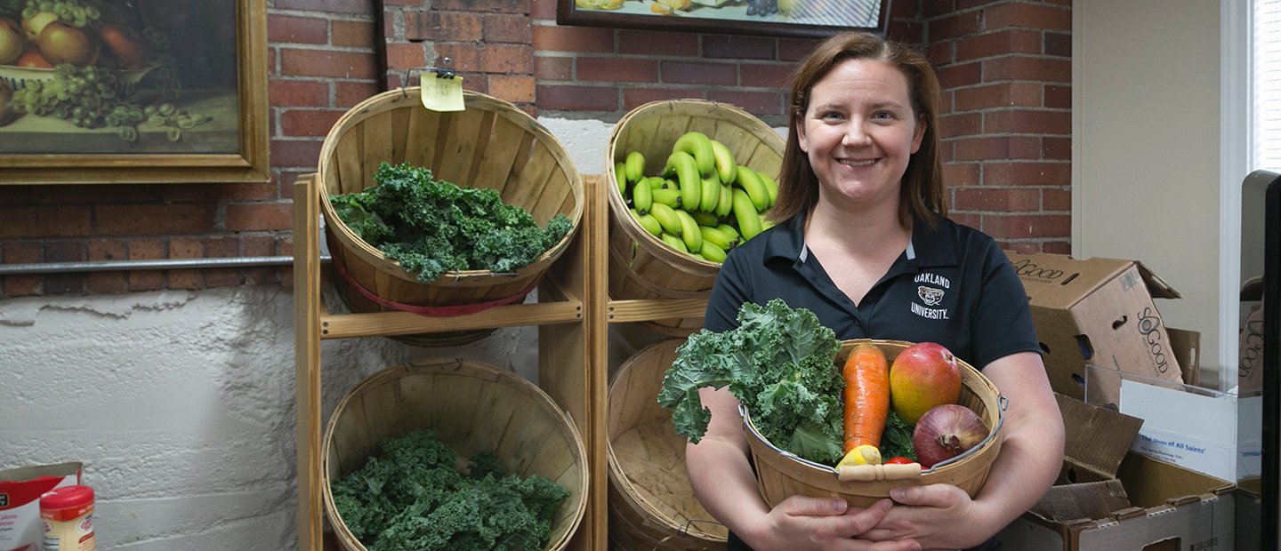 Sounding Series Banner A woman holding a basket of vegetables, in front of a shelf displaying more food.