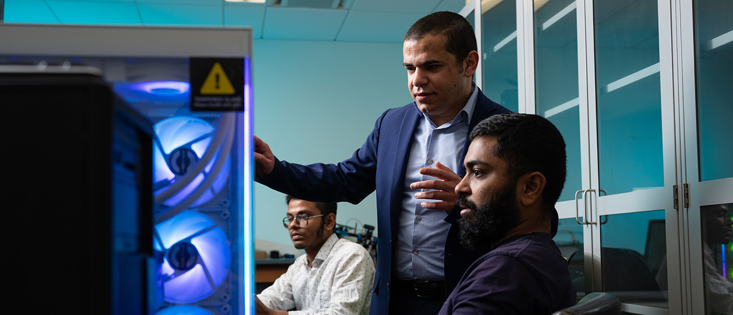 A professor and students in a lab