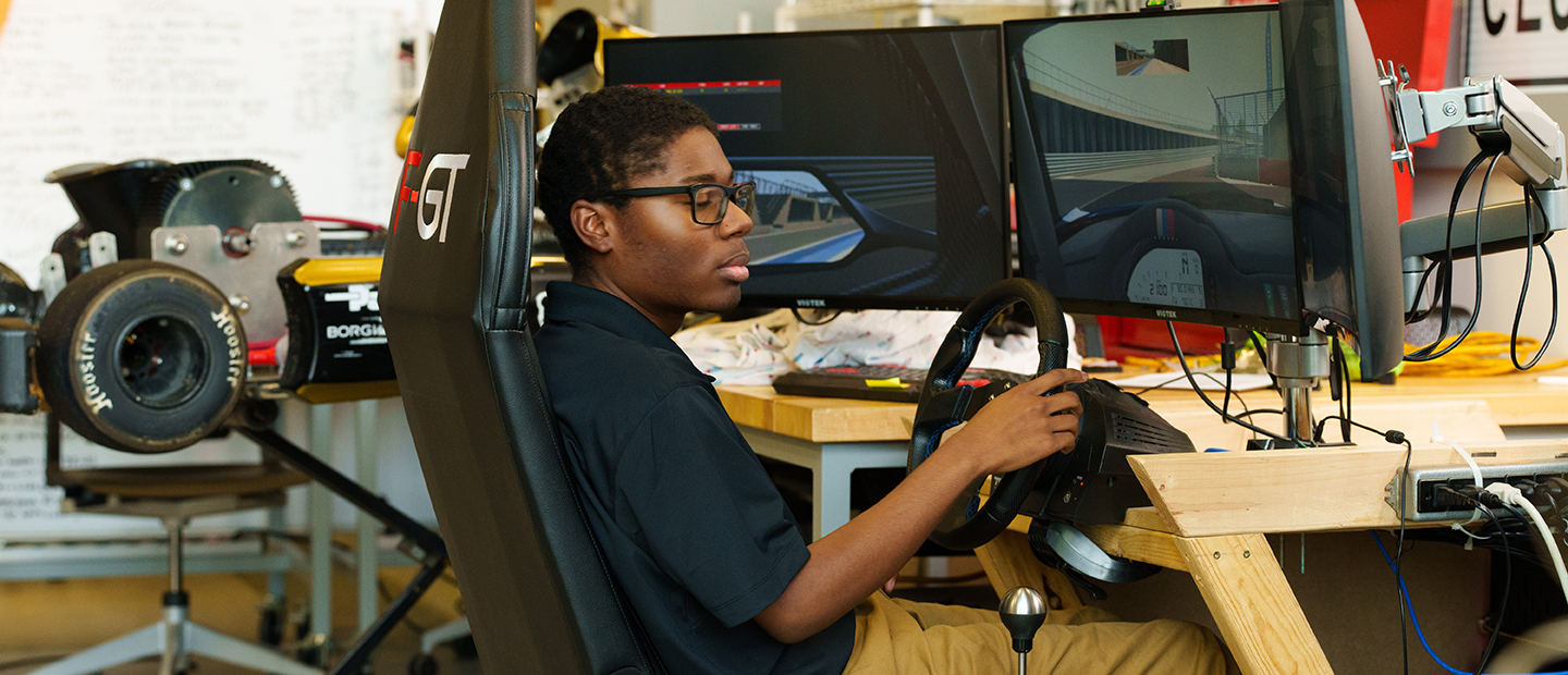 SECS Department Undergraduate Programs CE Banner A student seated at a driving simulation