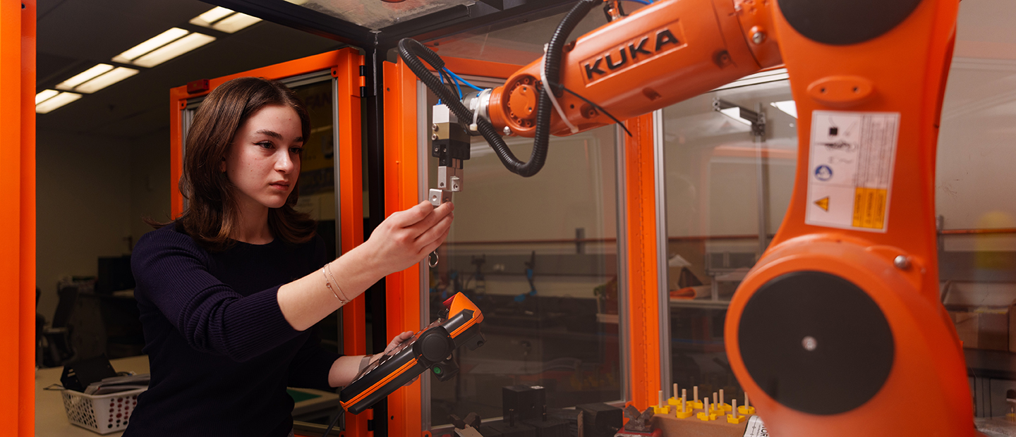 SECS Department Undergraduate Programs ISE Banner A woman working with industrial equipment