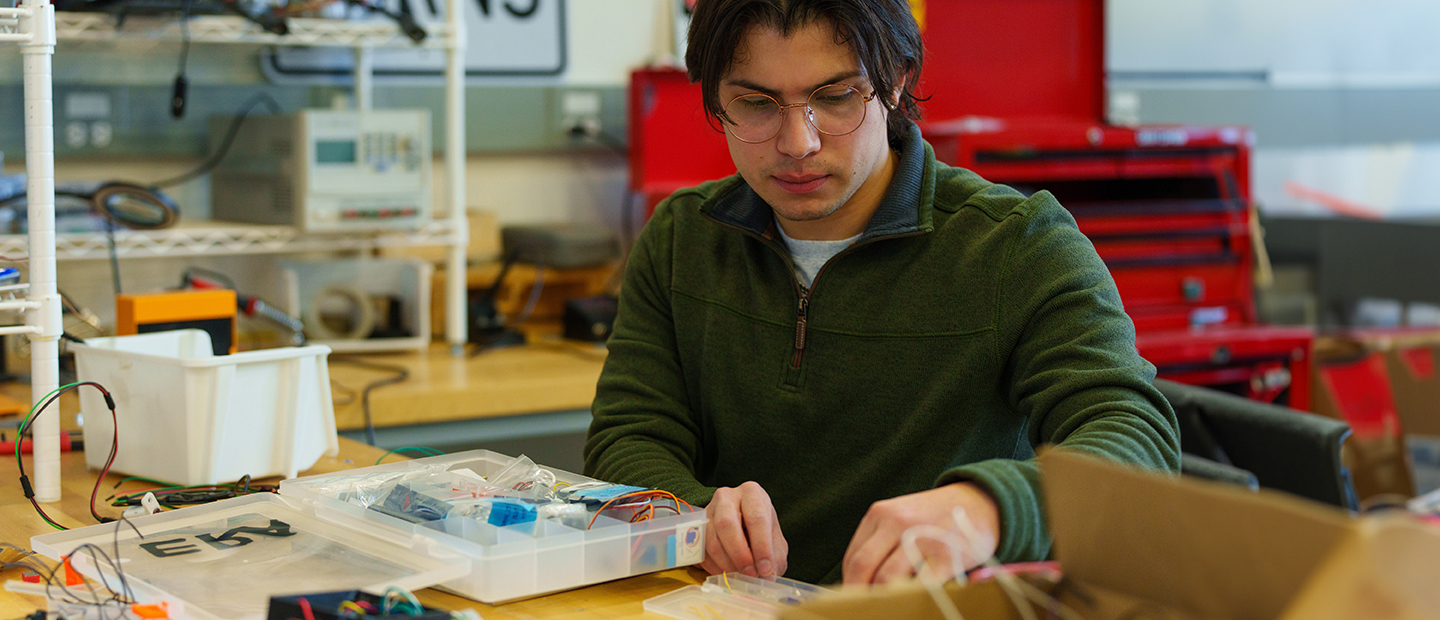 SECS Master of Science Programs Embedded systems Banner A student working in a lab with wires