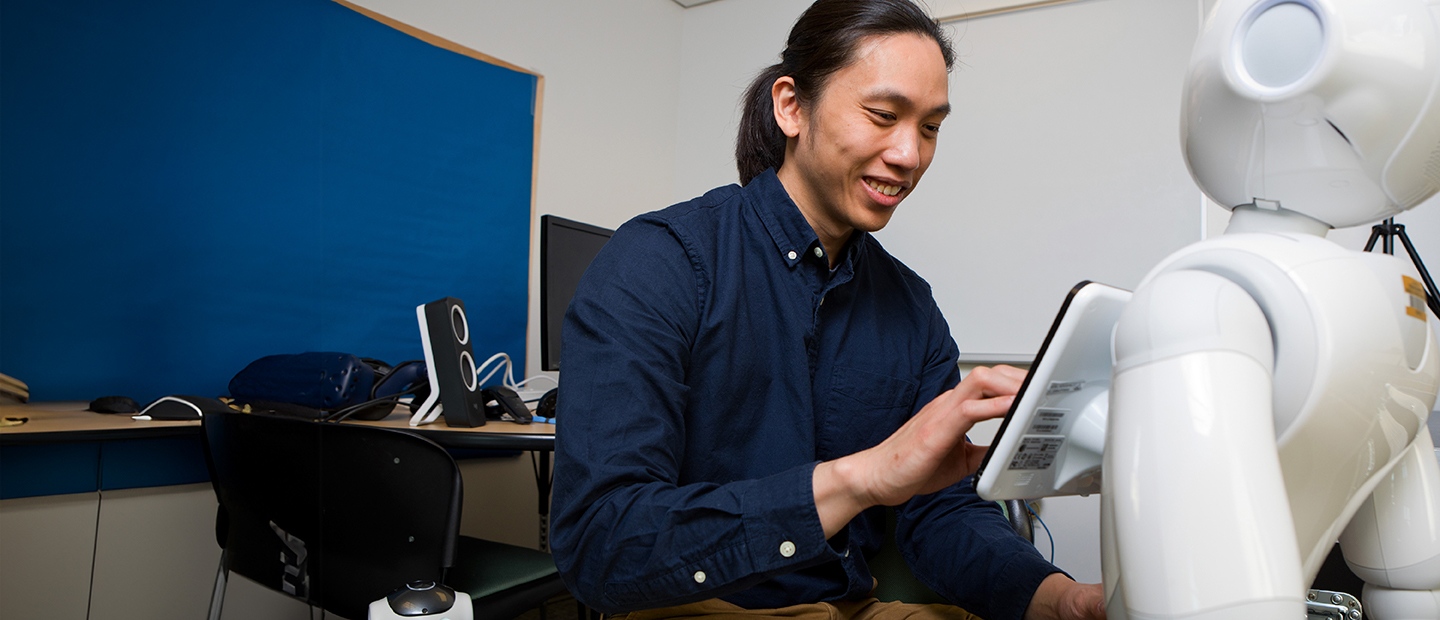 Undergraduate Programs Mechatronics and Robotics A man working on a robot