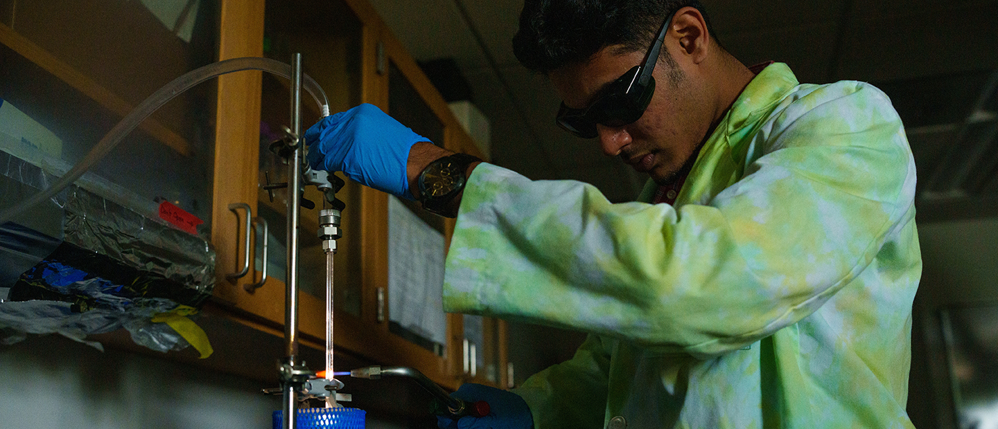 SECS Department Undergraduate Programs ES Banner A young man working in a science lab
