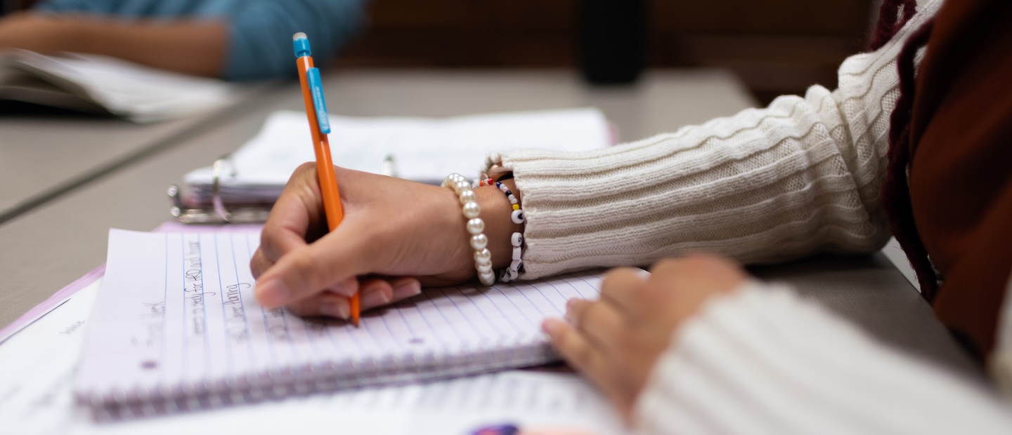Student Resources Banner Hands writing in a notebook