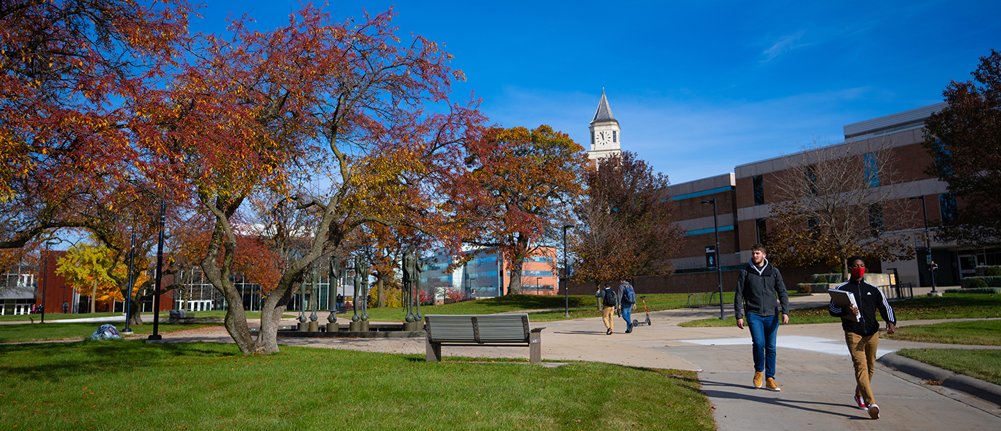 Students walking on Oakland University's campus in Fall.