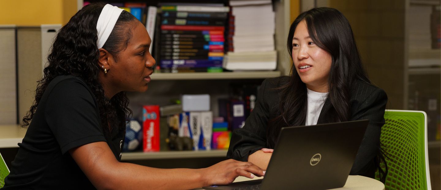 SHS Advising An adviser and student talking at a table.