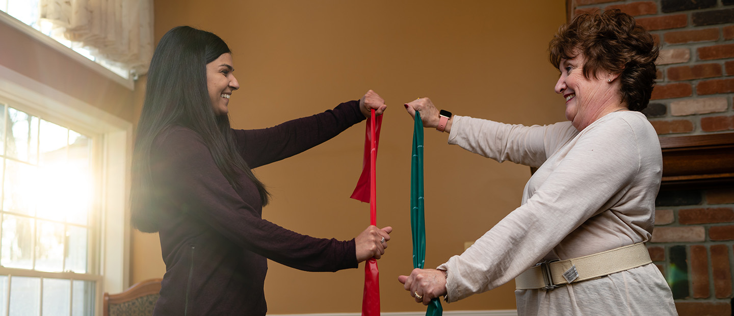 Physical therapy Student providing physical therapy to older person