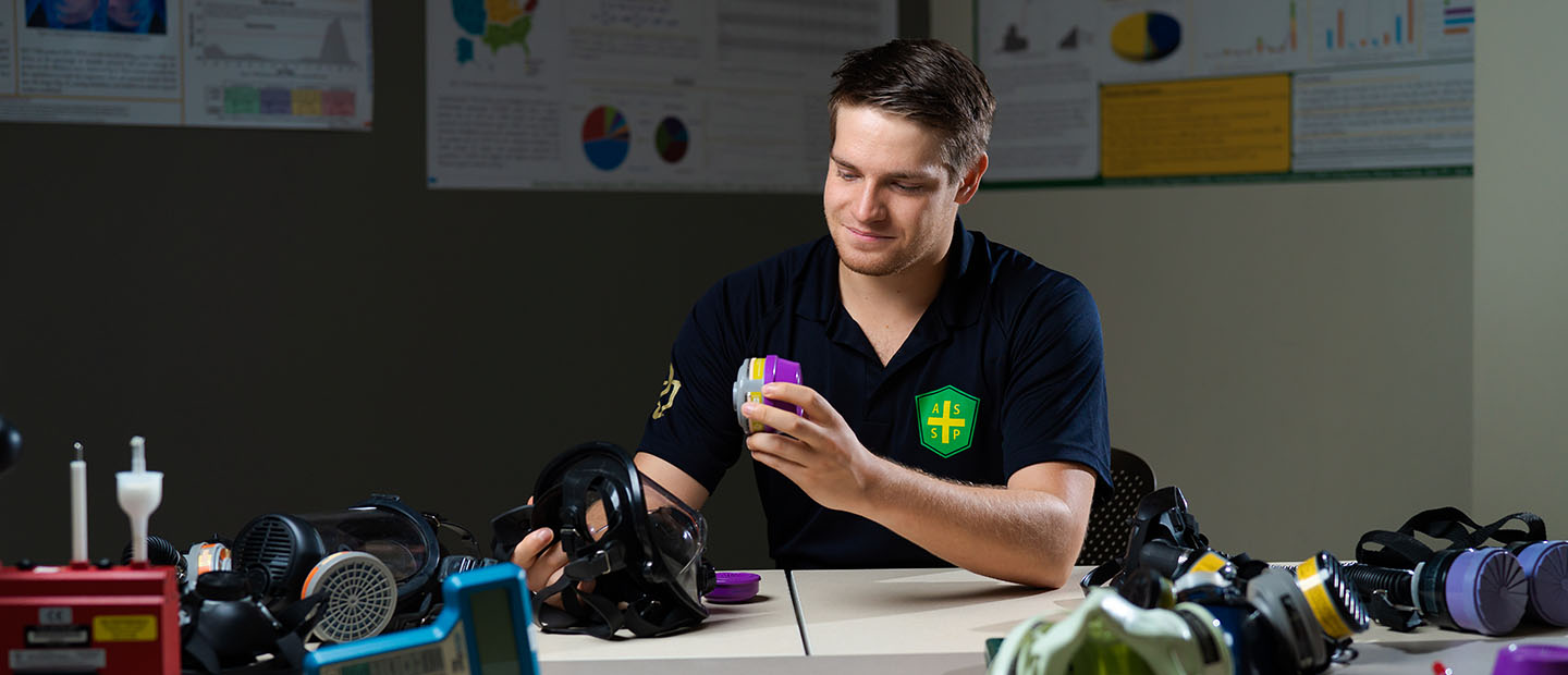 Ryan Papiernik working with environmental health and safety devices in a classroom