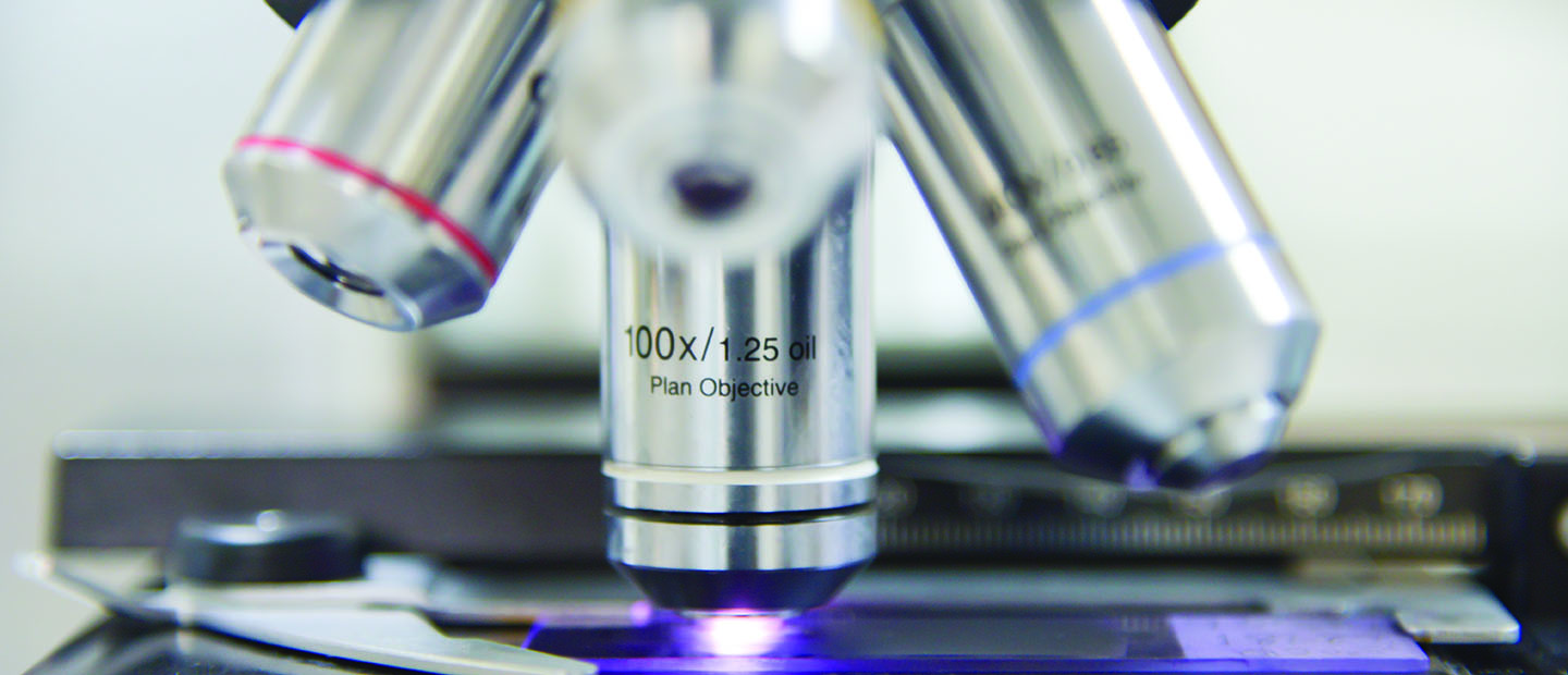 microscope Closeup image of a microscope and slide