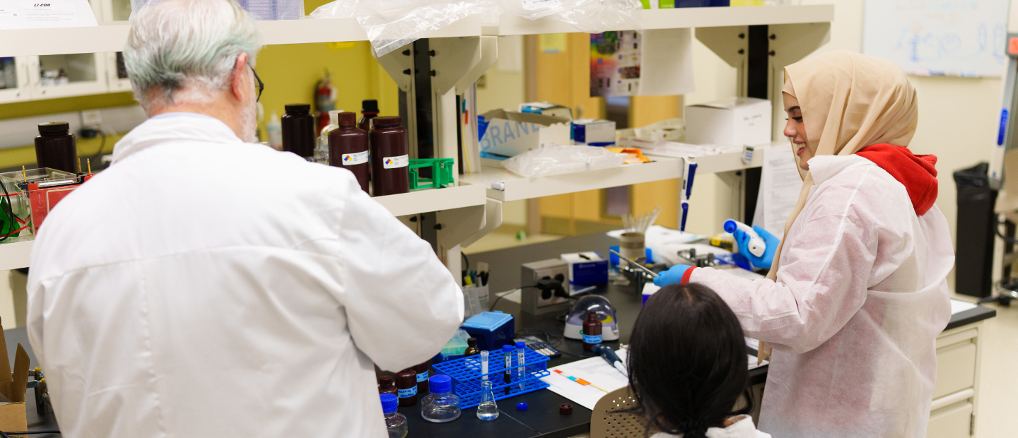 Three people working in lab Three people working together in a lab.