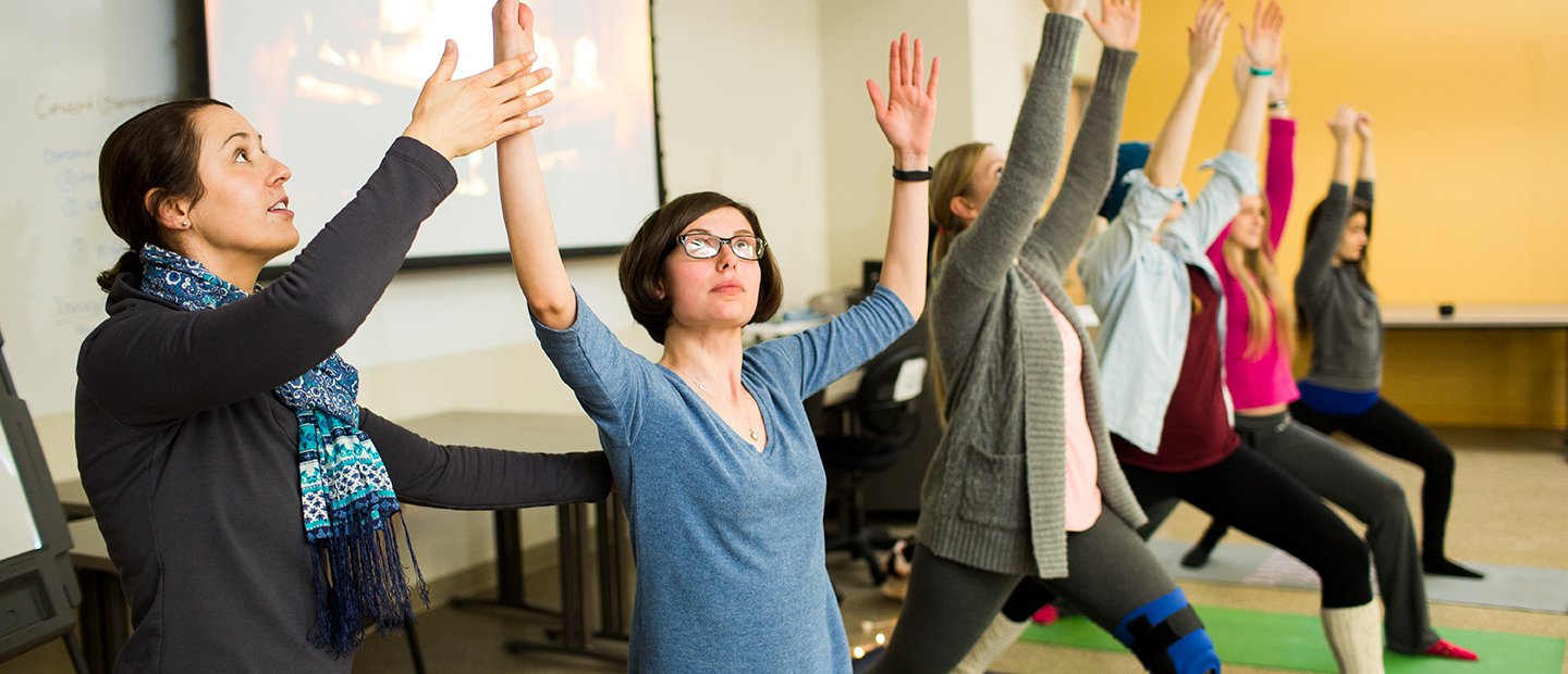 yoga class Woman leading a yoga class with five female students