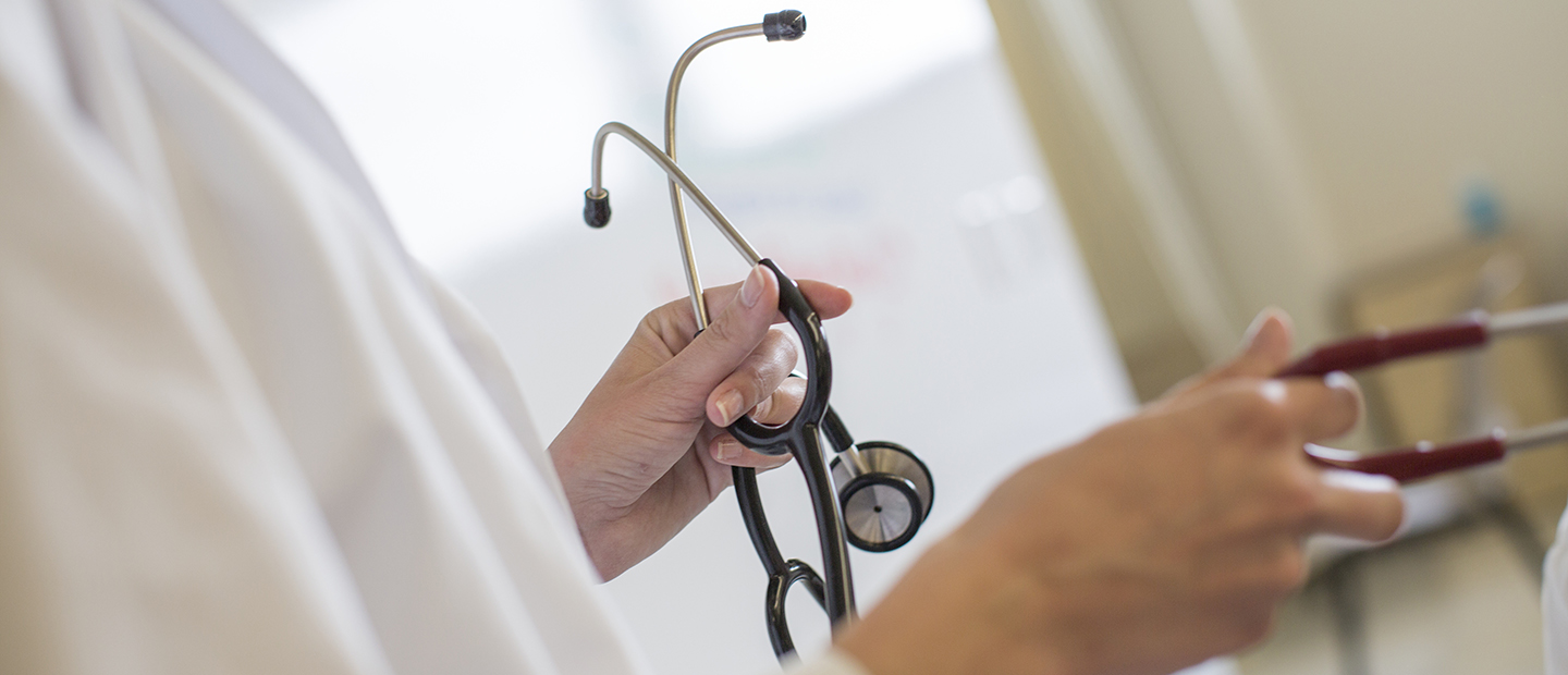A person's hand holding a stethoscope A person's hand holding a stethoscope.