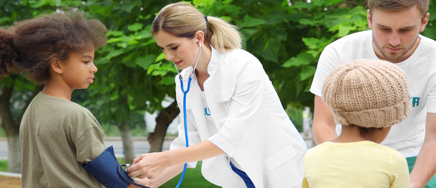 MD/MPH Medical professionals taking children's blood pressure
