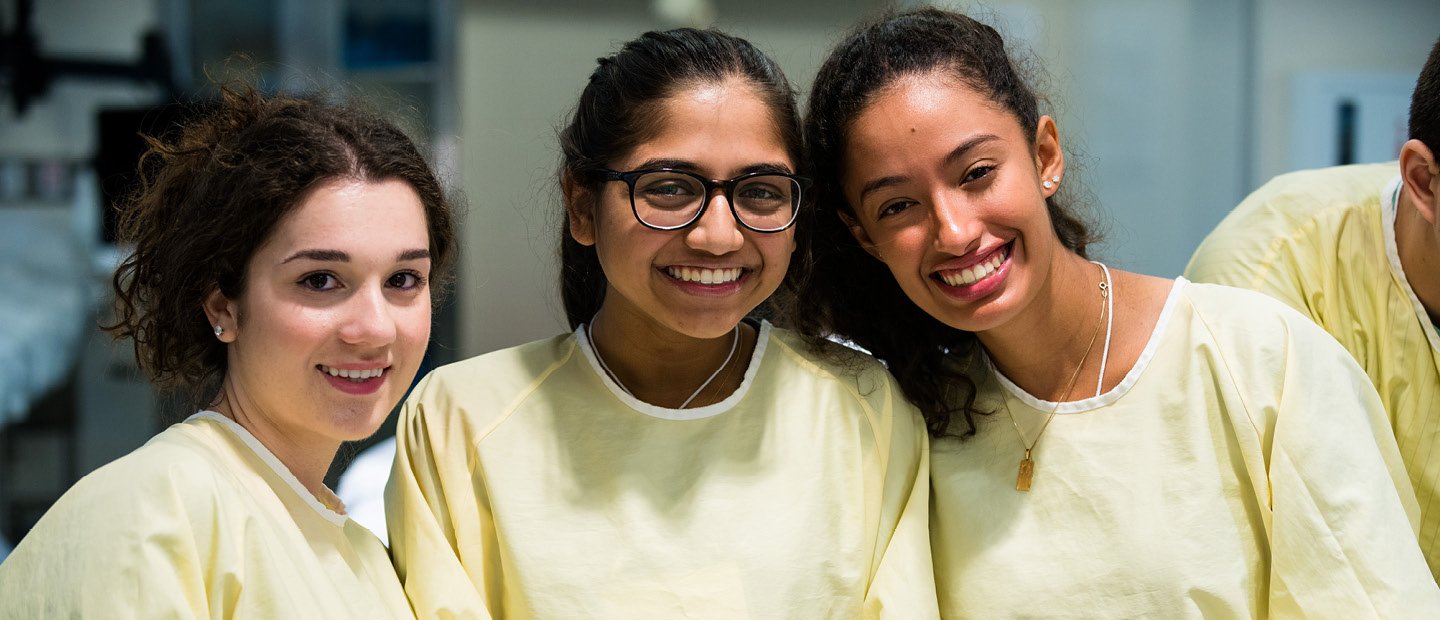 High School Students Banner three female students in yellow lab coats
