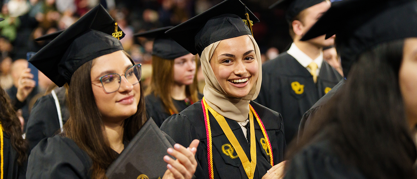 Golden Grizzlies Graduate Program Two Oakland University graduates at Commencement