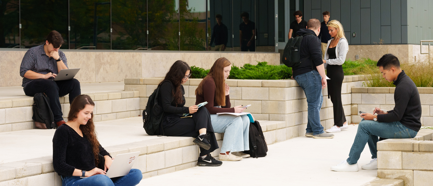 Resources Students scattered around the steps of a building at Oakland University