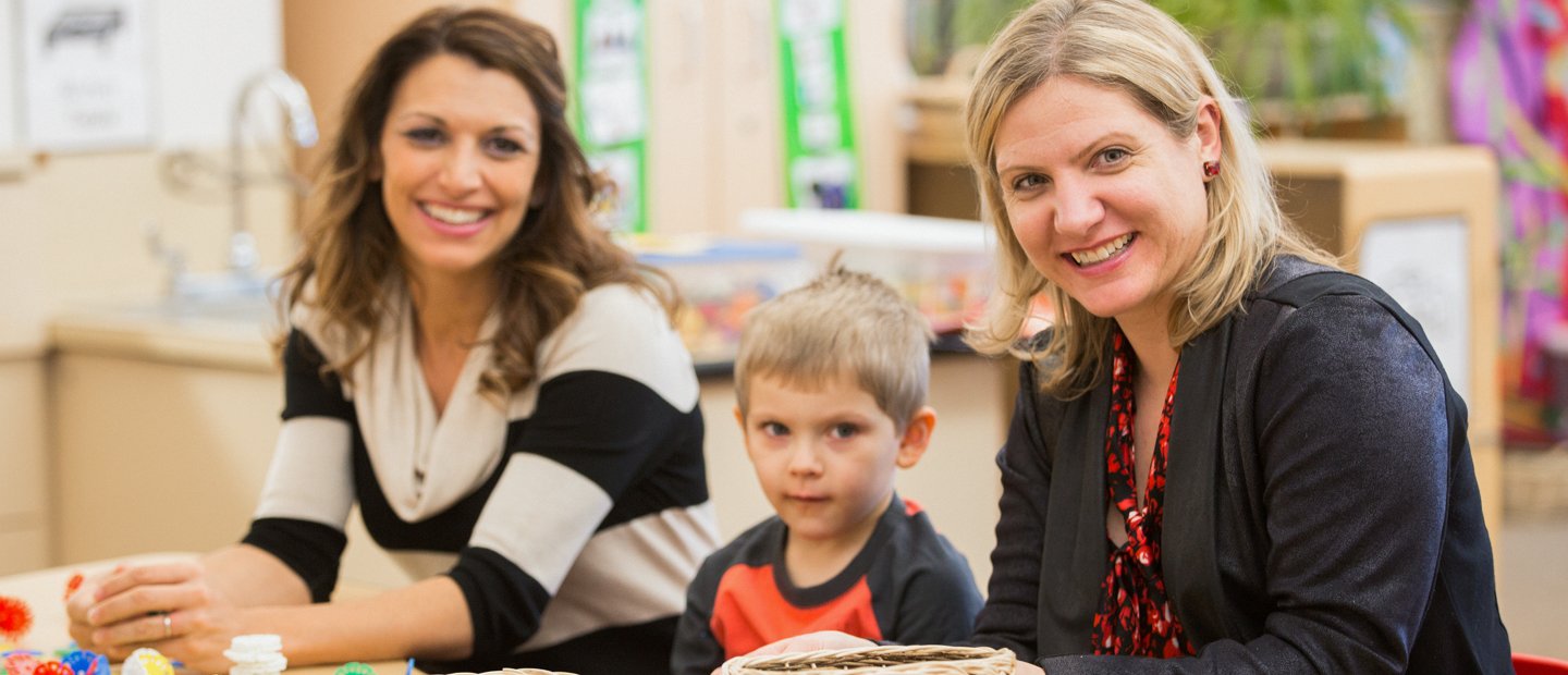 _0004_special-education_emotional-impairment-certificate-ei-endorsement.jpg Two women sitting next to a child