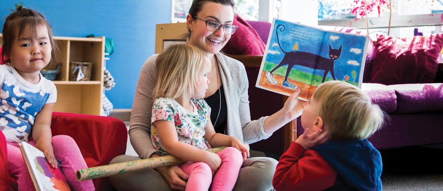 _0010_early-childhood-education_early-childhood-zs-endorsement.jpg Teacher sitting with child in her lap