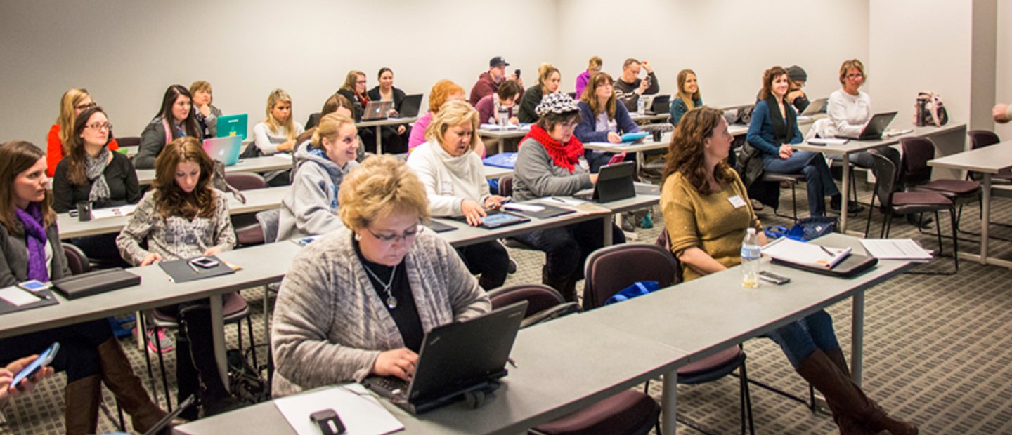 _0013_pdcourses.jpg Group of people sitting at desks