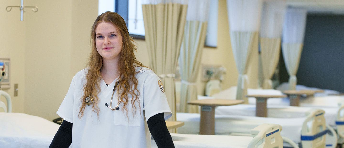 SON-25447_054 bsn basic.jpg student near lab bed