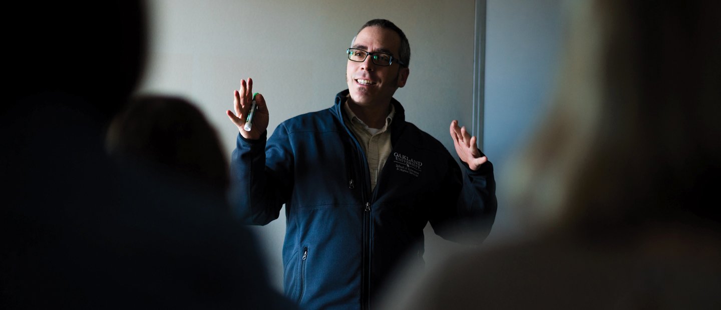 SFS Secondary Education.jpg A teacher standing in front of a class, gesturing with his hands.