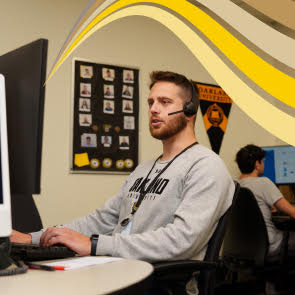 person wearing a headset on the computer